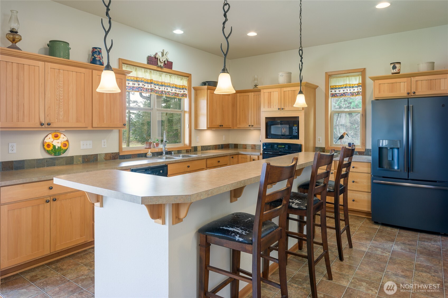 110 Clay Hill Road Lopez Island, WA 98261 - Photo 10 of 35 a kitchen with stainless steel appliances granite countertop a sink a stove and a refrigerator