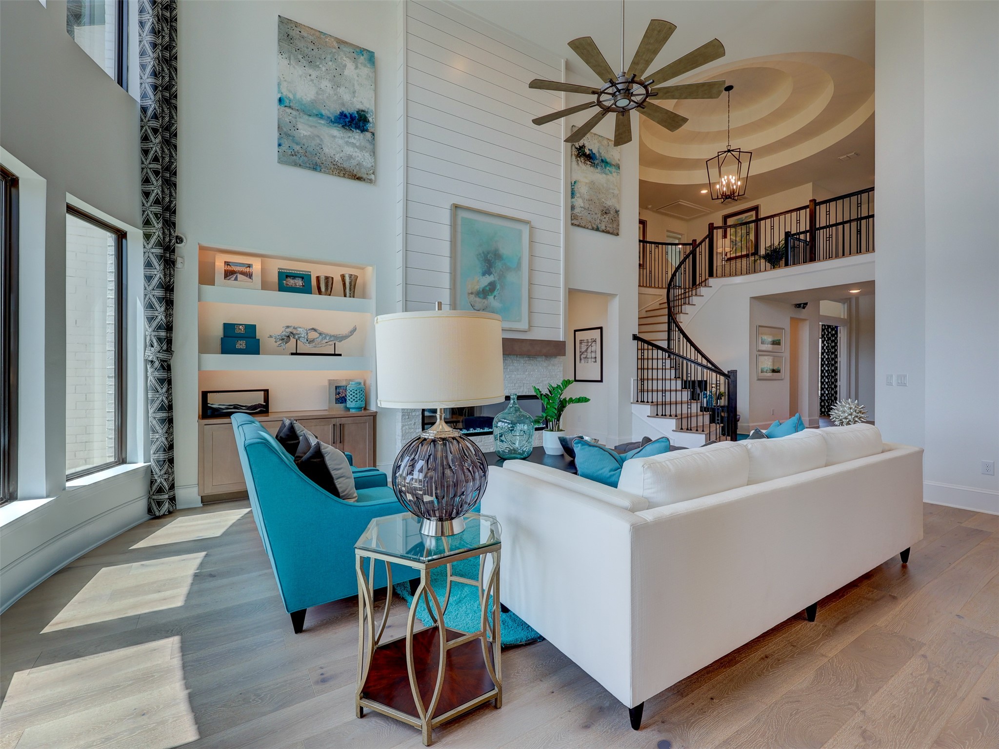 6220 Bower Well Road Austin, TX 78738 - Photo 7 of 28 A grand living space with a soaring two-story ceiling, elegant staircase, and sun-filled windows.