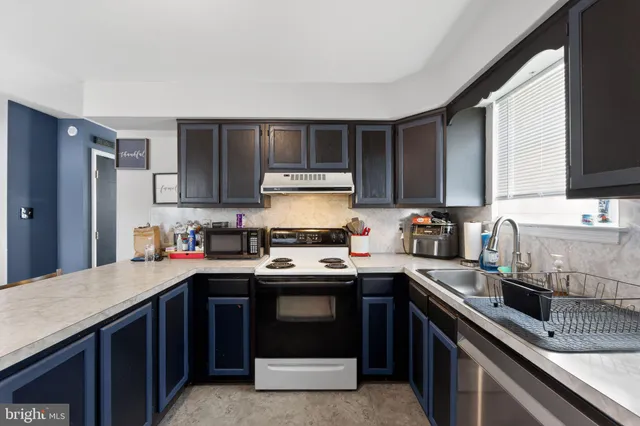 a kitchen with stainless steel appliances a sink stove and refrigerator
