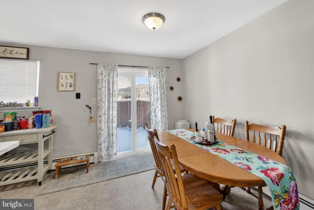a view of a dining room with furniture and a window