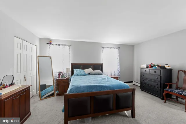 a bedroom with a bed a table and chair