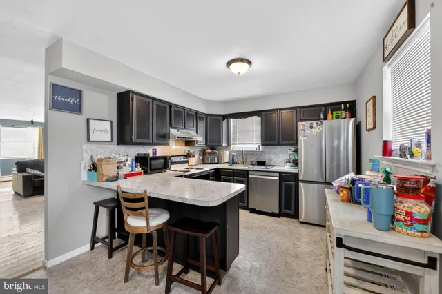 a kitchen with refrigerator and cabinets