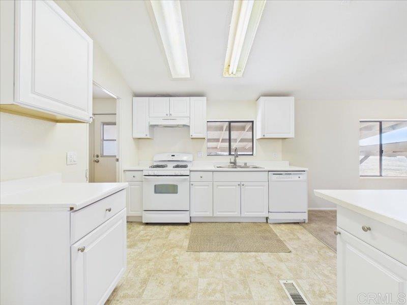 37589 Montezuma Valley Road Ranchita, CA 92066 - Photo 20 of 43 a kitchen with white cabinets and white appliances