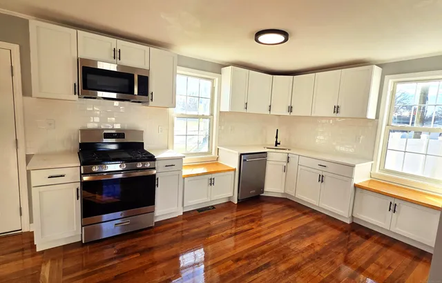 a kitchen with a stove a sink and a microwave