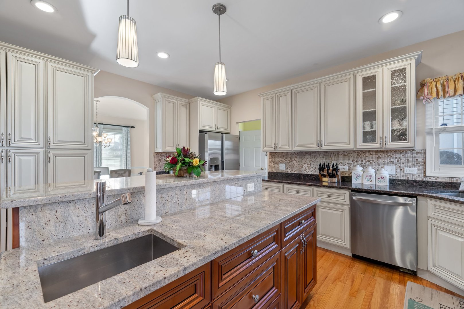2527 Wild Timothy Road Naperville, IL 60564 - Photo 12 of 38 a kitchen with stainless steel appliances granite countertop a sink a stove and a wooden floors