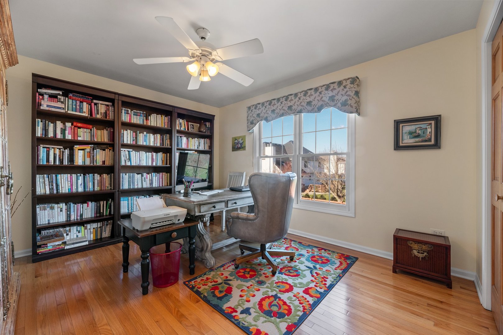 2527 Wild Timothy Road Naperville, IL 60564 - Photo 24 of 38 a view of a workspace with furniture and a bookshelf