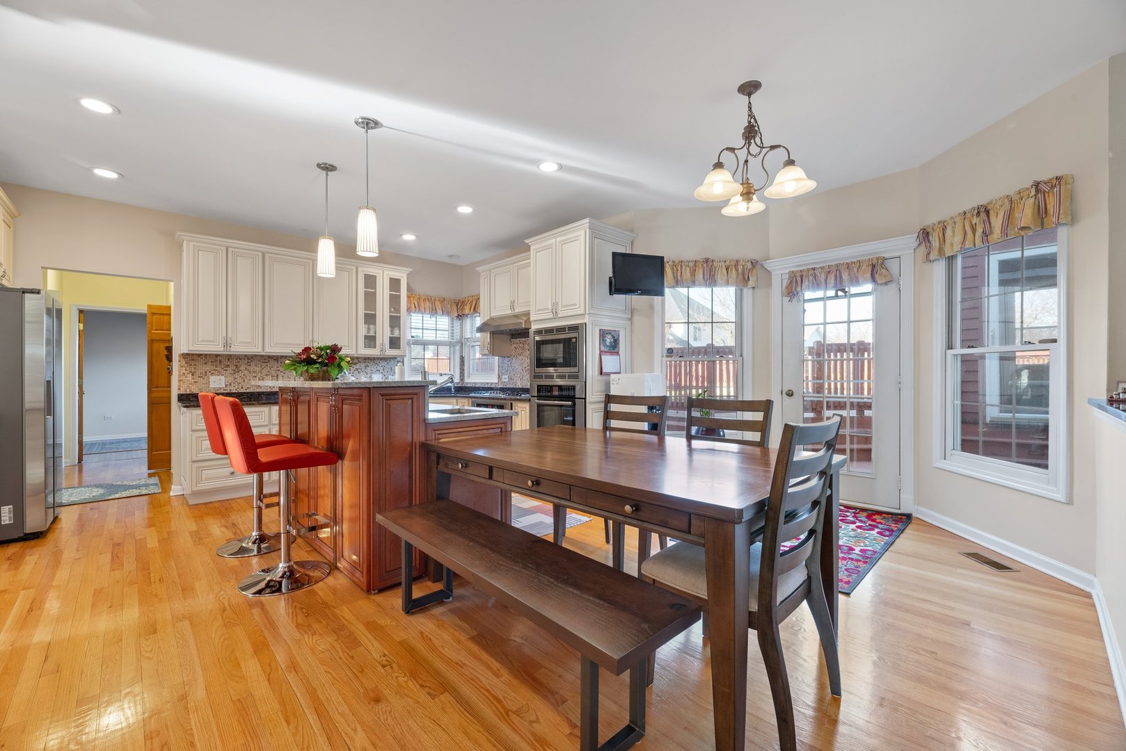 2527 Wild Timothy Road Naperville, IL 60564 - Photo 10 of 38 a room with stainless steel appliances kitchen island granite countertop a dining table chairs refrigerator and cabinets