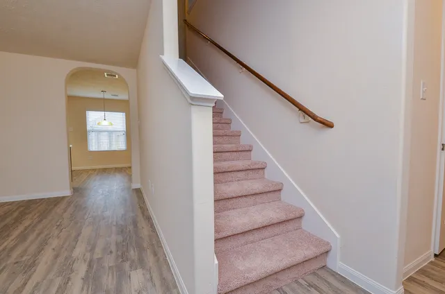 a view of entryway and hall with wooden floor