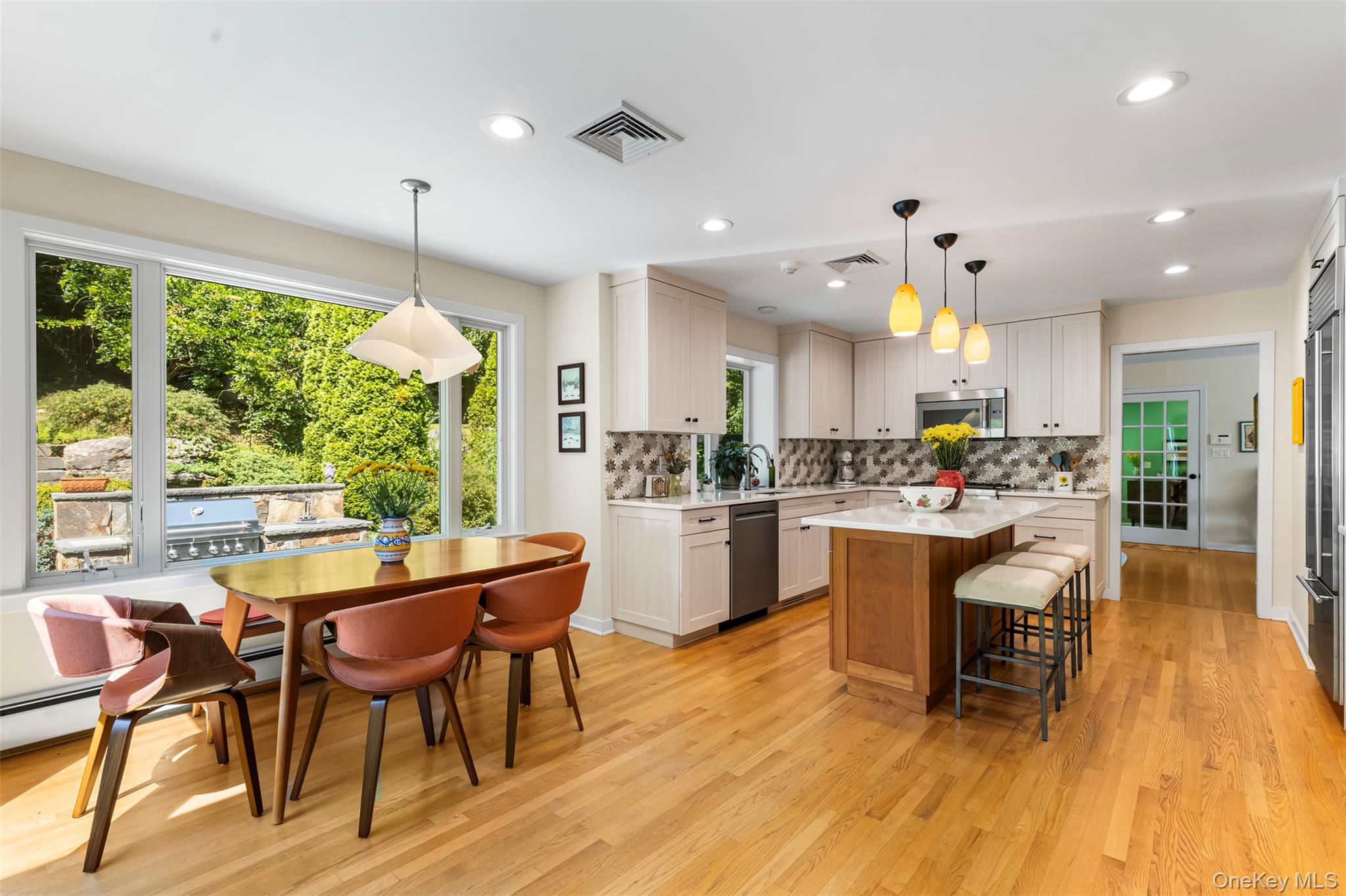 507 Croton Lake Road Bedford Corners, NY 10549 - Photo 14 of 39 a kitchen with stainless steel appliances a dining table chairs and wooden floor