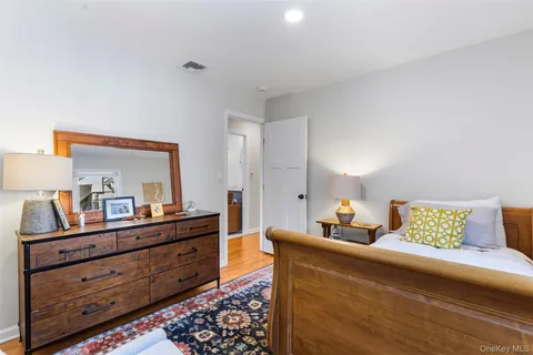 a living room with furniture and a dresser