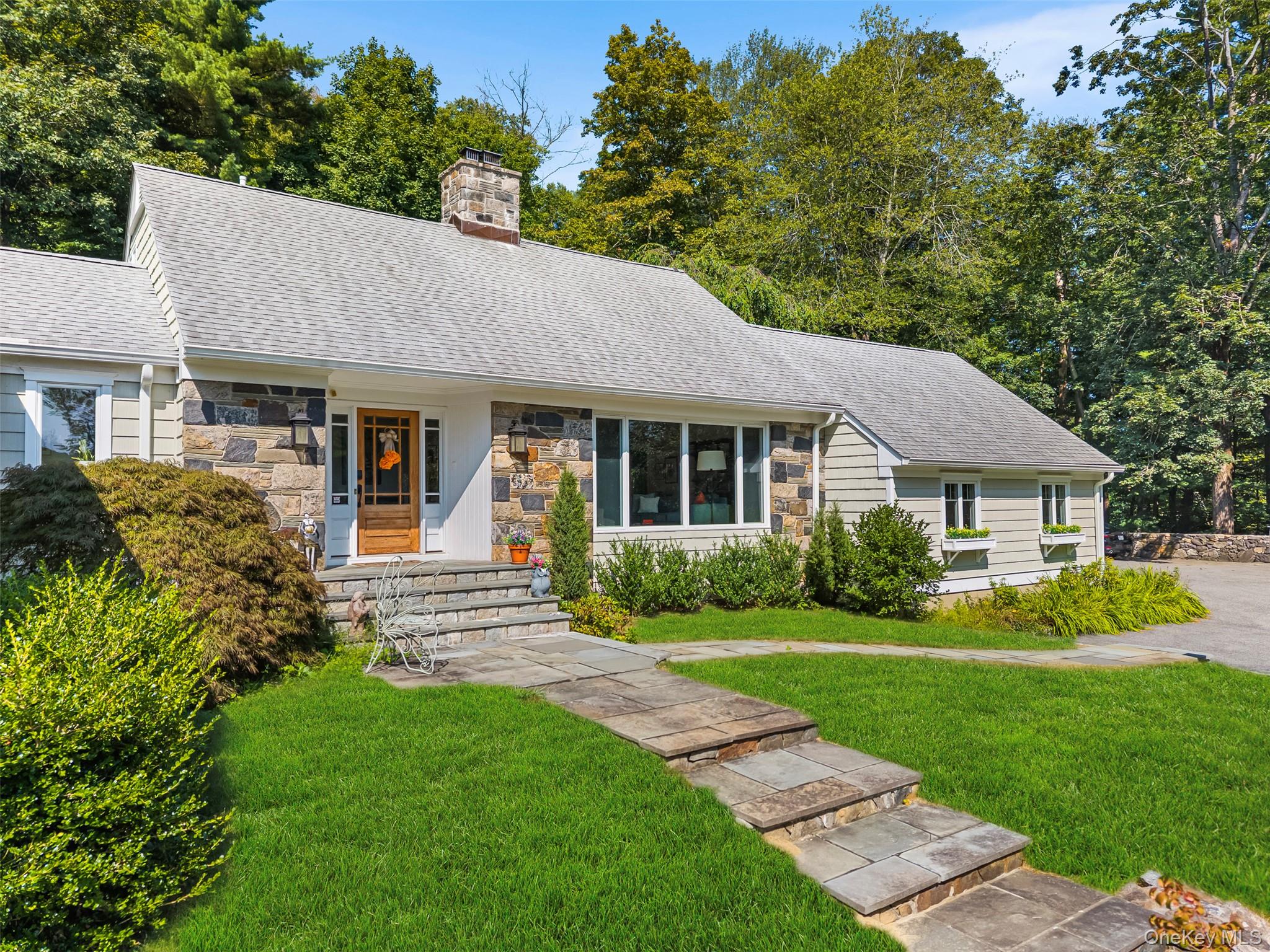 507 Croton Lake Road Bedford Corners, NY 10549 - Photo 36 of 39 a front view of a house with a garden