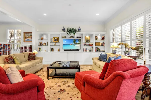 a living room with furniture fireplace and a large window