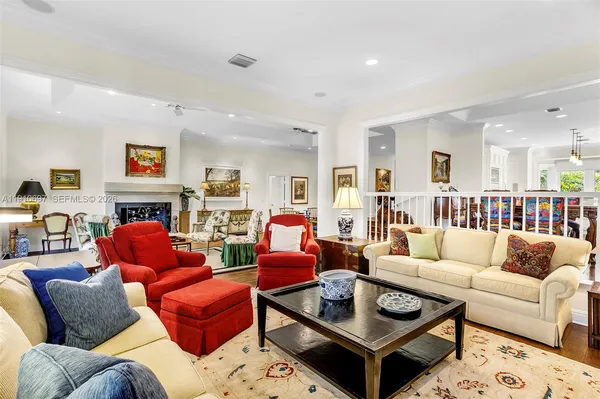 a living room with furniture kitchen view and a fireplace