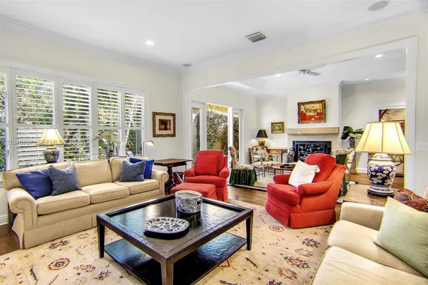 a living room with furniture a rug and a large window