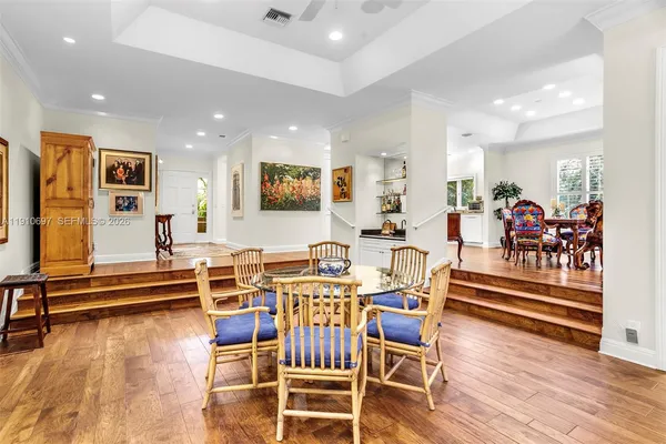 a view of a dining room with furniture wooden floor and windows