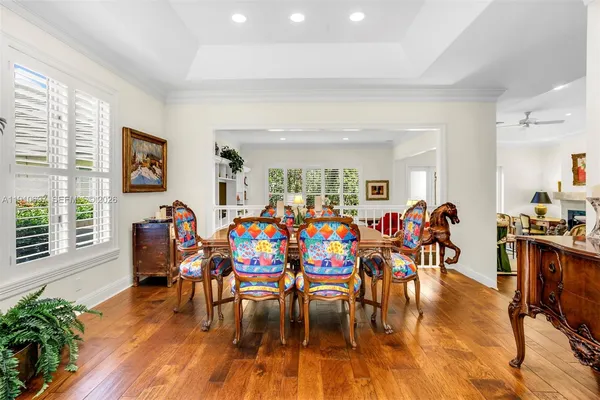 a view of a dining room with furniture and wooden floor