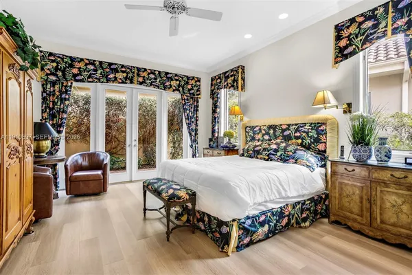 a bedroom with a large bed and windows