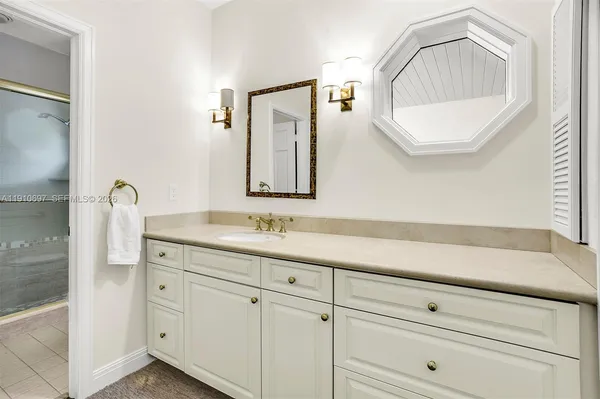a bathroom with a sink a mirror and a vanity
