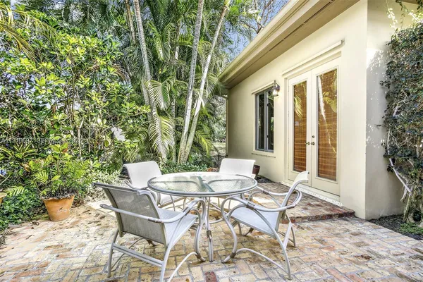 a view of a patio with table and chairs and potted plants