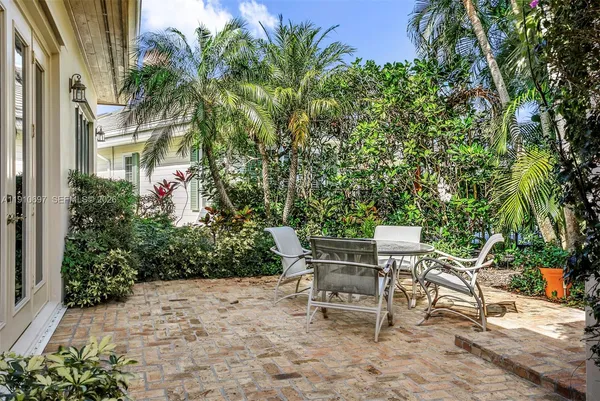 a backyard of a house with table and chairs