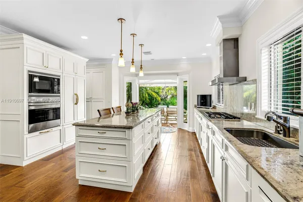 a kitchen with stainless steel appliances a stove sink and cabinets