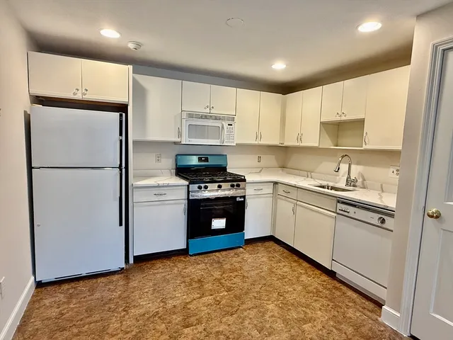 a kitchen with a refrigerator stove and sink
