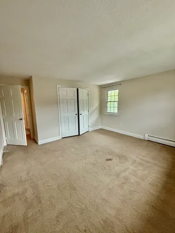 an empty room with a empty space and windows