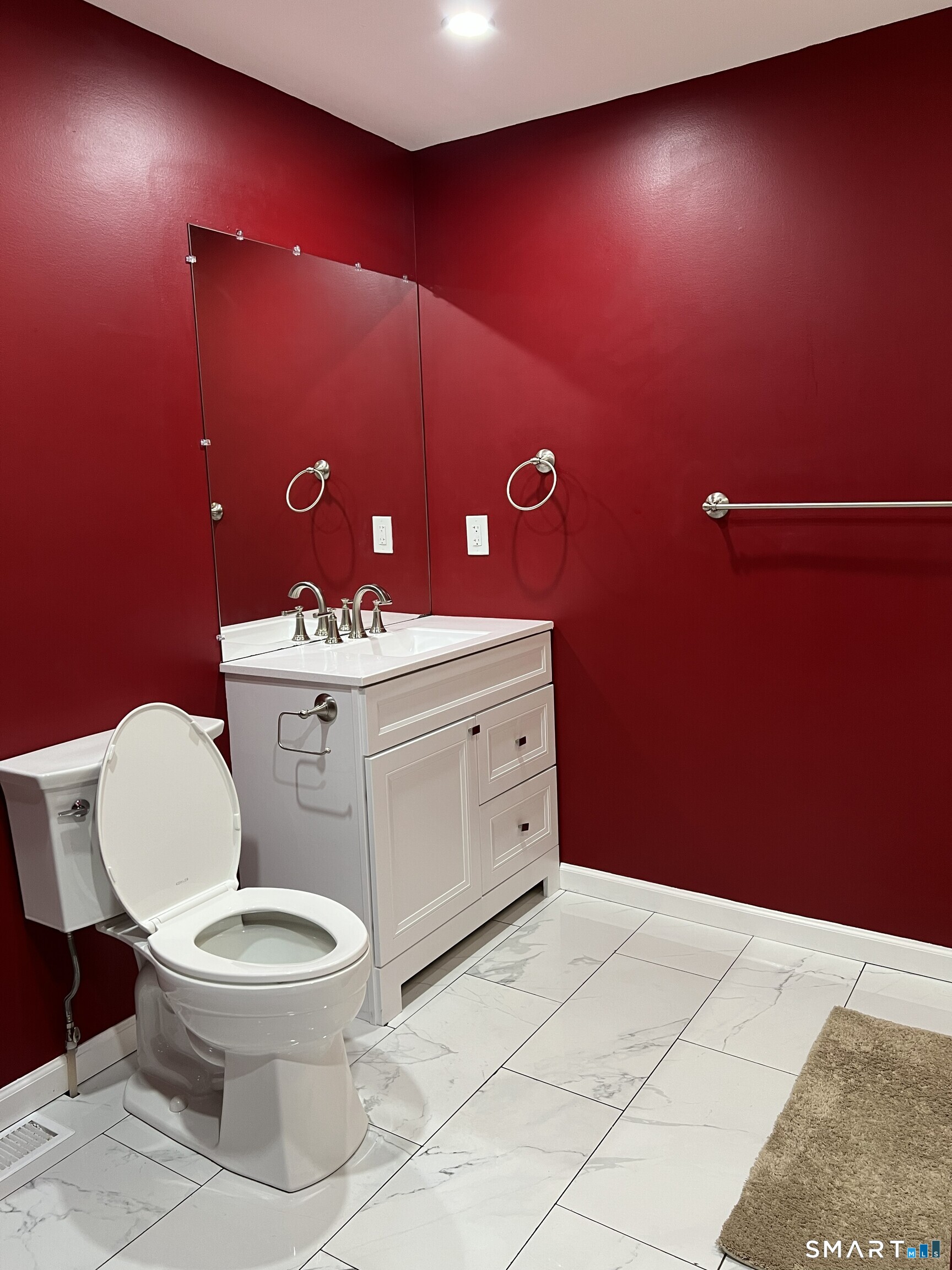 82 Bingham Street Bristol, CT 06010 - Photo 15 of 40 a bathroom with a toilet a sink and mirror