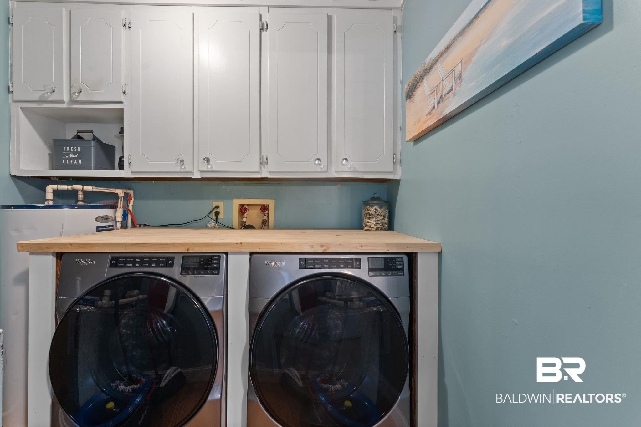 3881 Oregon Avenue Coden, AL 36523 - Photo 12 of 19 Laundry area with cabinet space and washing machine and clothes dryer