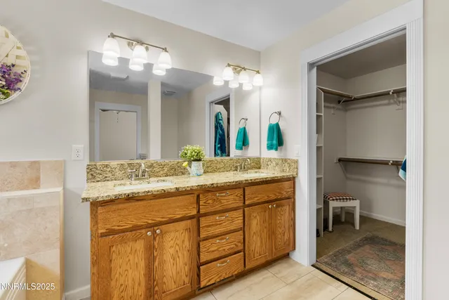 a bathroom with a granite countertop sink a toilet and a mirror