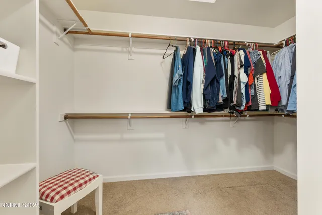 a view of walk in closet with clothes