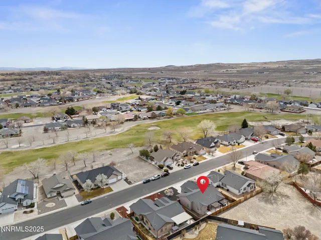 an aerial view of residential houses with outdoor space