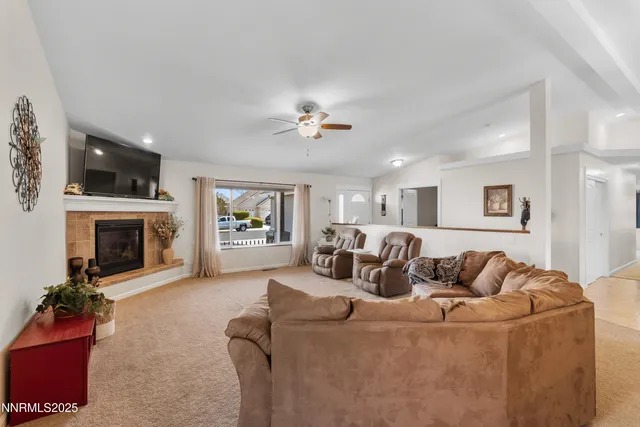 a living room with furniture fireplace and flat screen tv