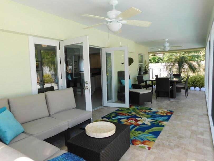 1150 Emerald Lane Singer Island, FL 33404 - Photo 10 of 19 a living room with furniture and a large window