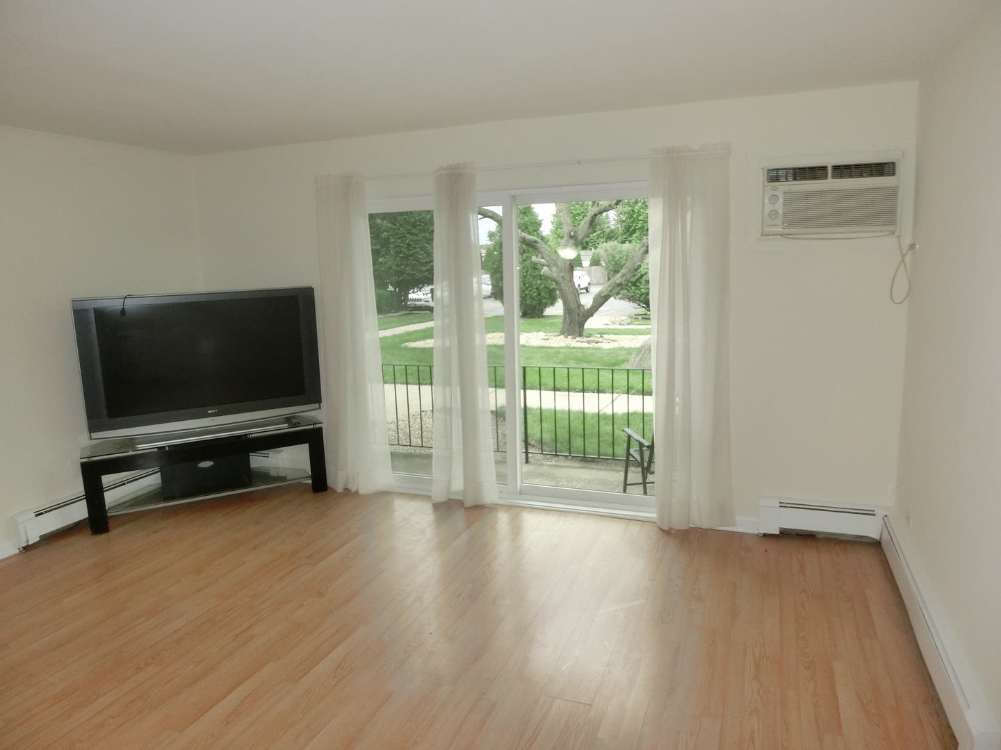 10324 South Ridgeland Avenue, Unit 105 Chicago Ridge, IL 60415 - Photo 2 of 16 a living room with furniture and a flat screen tv