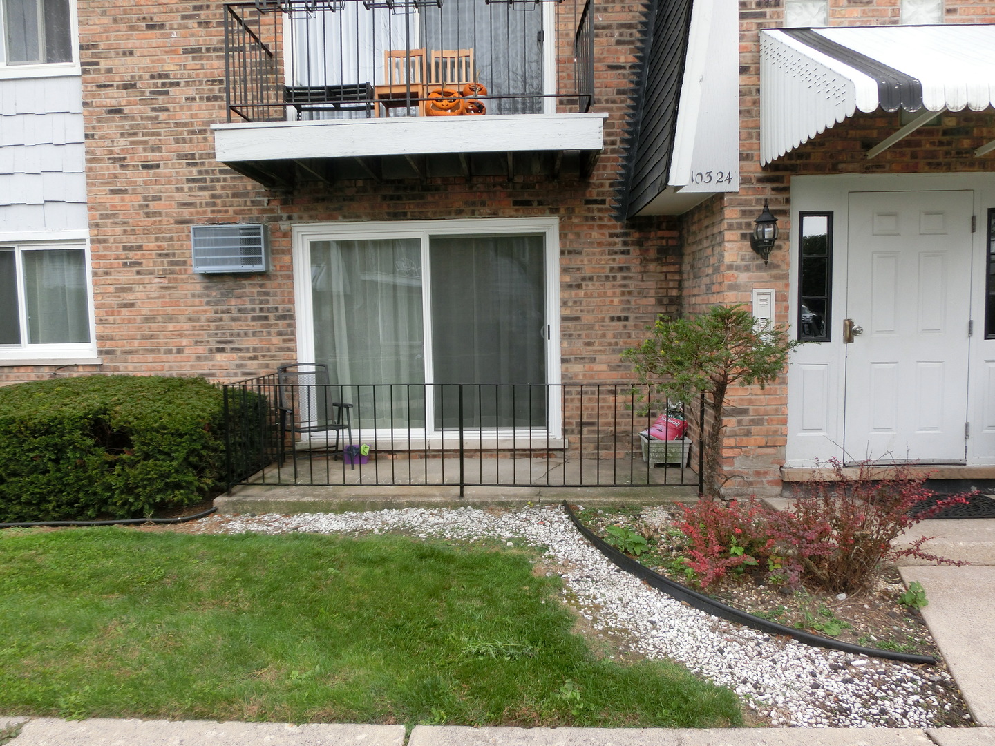 10324 South Ridgeland Avenue, Unit 105 Chicago Ridge, IL 60415 - Photo 15 of 16 a front view of a house with a garden and plants