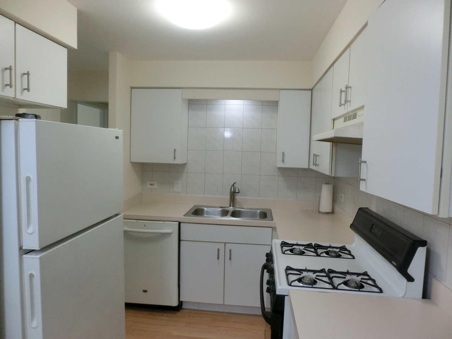 10324 South Ridgeland Avenue, Unit 105 Chicago Ridge, IL 60415 - Photo 5 of 16 a kitchen with a sink a stove and refrigerator