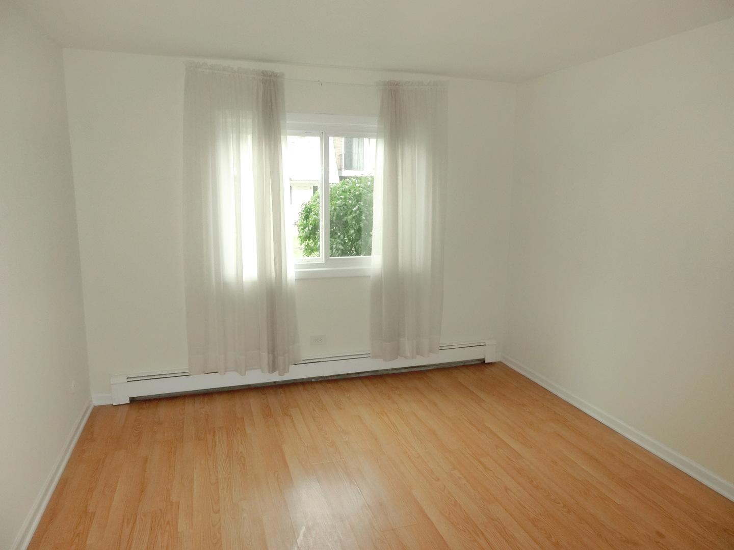 10324 South Ridgeland Avenue, Unit 105 Chicago Ridge, IL 60415 - Photo 7 of 16 an empty room with wooden floor and windows