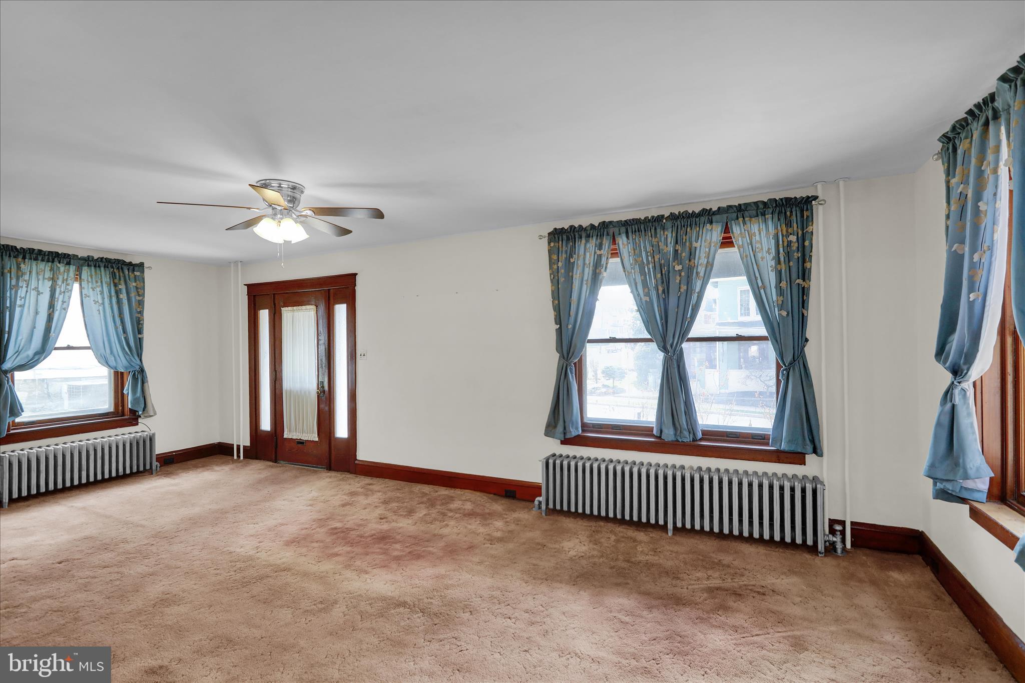 4205 Penn Avenue Reading, PA 19608 - Photo 14 of 54 an empty room with windows and chandelier fan