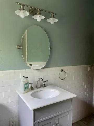 a bathroom with a sink and mirror