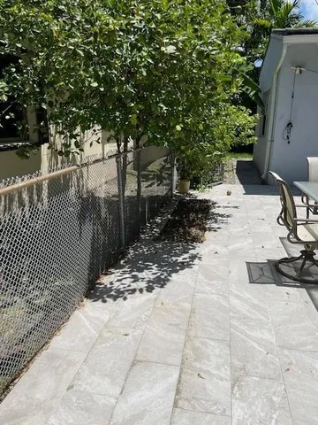 a view of a yard with plants and trees