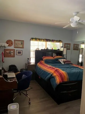 a bedroom with bed and window