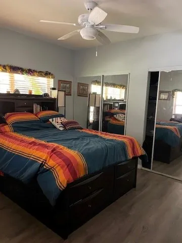 a bedroom with a bed and a flat tv screen on dresser