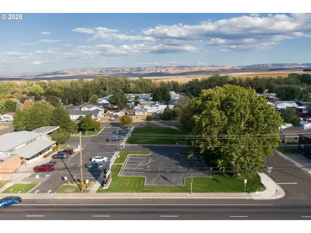 an aerial view of a house with a yard basket ball court and outdoor view