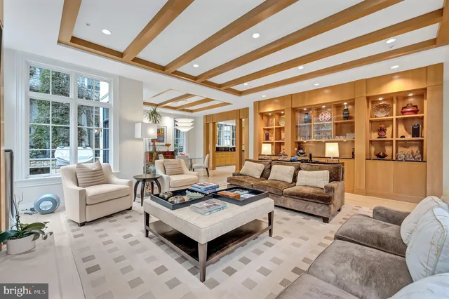 a living room with fireplace furniture and a large window