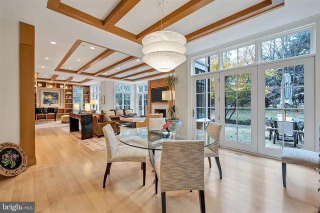 a kitchen with a stove a sink a dining table and chairs