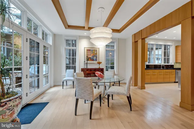 a kitchen with a table chairs refrigerator and cabinets