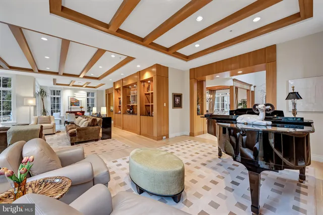a living room with furniture fireplace and a large window