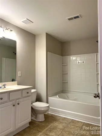 a bathroom with a toilet a sink and bathtub