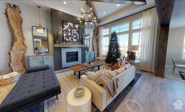 1547 North 1350 E Street, Unit 2 Mapleton, UT 84664 - Photo 2 of 18 Living area with wood finished floors, a glass covered fireplace, recessed lighting, and a chandelier